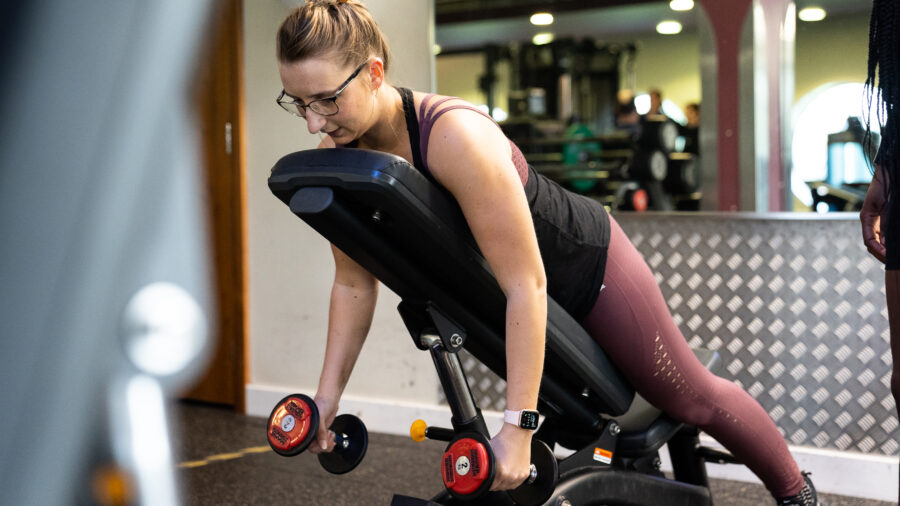 Women performing chest supported dumbbell rows