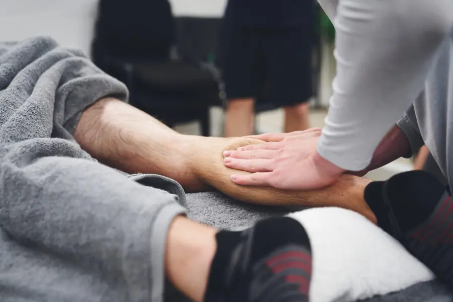 Image of someone massaging someone's calf