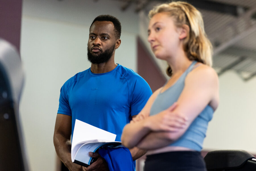 Man and Woman Standing listening to instructor (out of picture)